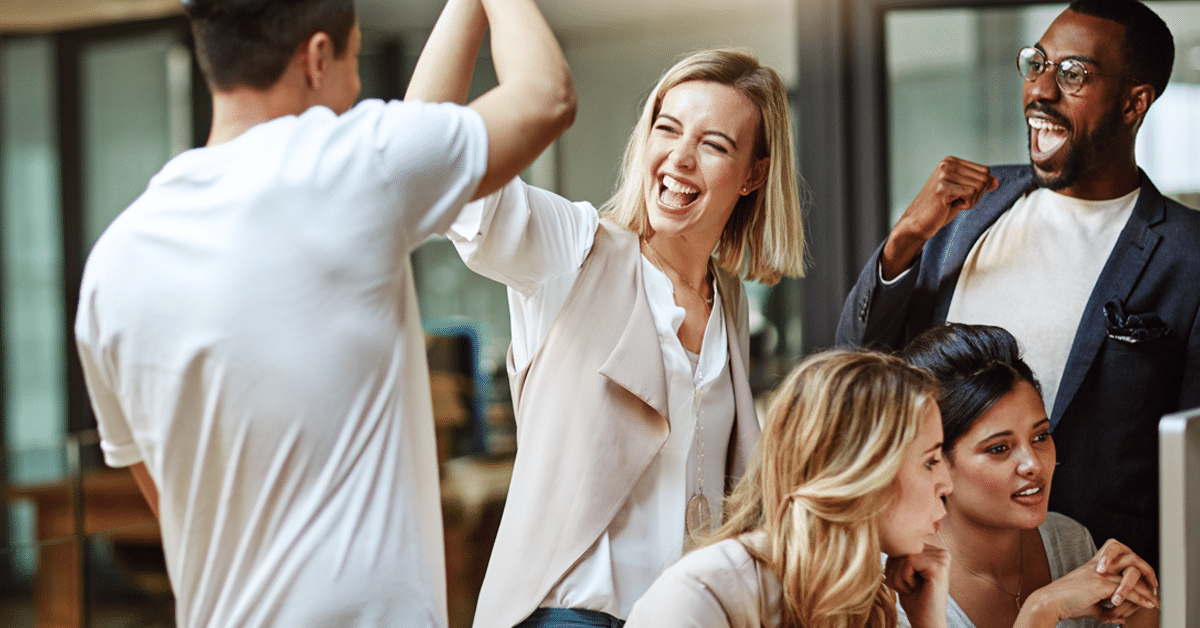 Group of coworkers excited and high-fiving